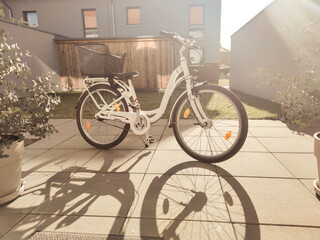 Child city bike is on modern terrace in backyard at sunny day