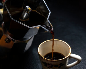 fresh dark roast coffee brew in espresso moka pot Italian style