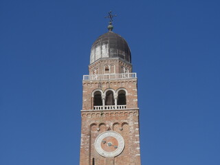 Fototapeta na wymiar Chioggia, Cathedral of Santa Maria bell tower in Romanesque style with Zuanne Miller clock