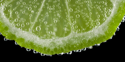 Fototapeta na wymiar Green lime with bubbles on black background