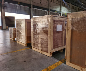 Worker sorting shipment cartons box on pallets and wooden case on hand lift in interior warehouse cargo for export and sorting goods in freight logistics transportation industrial, delivery service