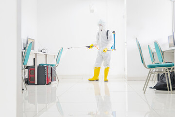 Disinfector clean office room with disinfectant spray