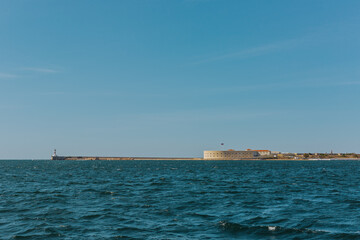 Konstantinovskaya battery, and a pier with a lighthouse at the exit from Sevastopol Bay in the Black sea