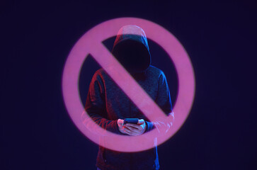 Dangerous hacker with smartphone in hands. Internet, cyber crime, cyber attack, system, game, breaking and malware concept. Dark background.