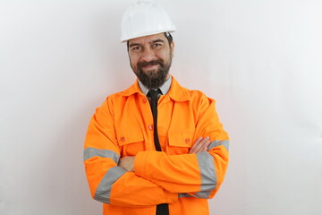 Handsome bearded man wearing worker uniform and hardhat happy face smiling with crossed arms looking at the camera. Achievement career 