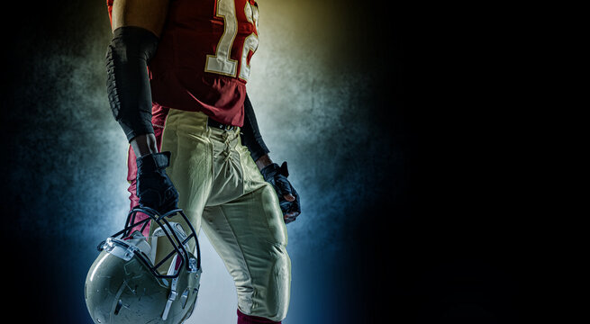 Sportsman with ball in helmet on stadium in action. Sport wallpaper. Team sports.