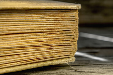 Close up fragment of an old shabby book texture background. Knowledge, science and education concept.