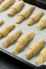 Homemade raw croissant on a tray 