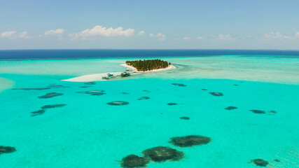 Tropical island in the ocean with palm trees on white sand beach. Onok Island, Balabac, Philippines. Summer and travel vacation concept