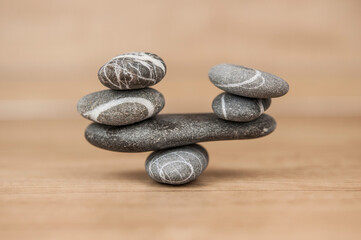 Stone cairn on wood background, simple poise stones, simplicity harmony and balance, rock zen sculptures