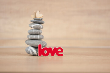 Stone cairn on wood background, simple poise stones, simplicity harmony and balance, rock zen sculptures
