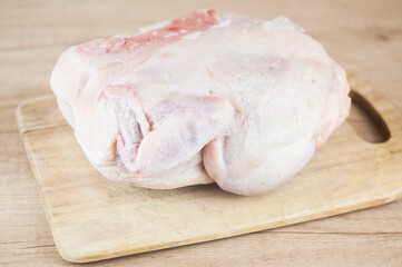 Frozen chicken in the frost on the table