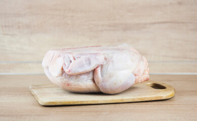 Frozen chicken in the frost on the table