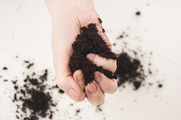 A pile of soil in female hands.