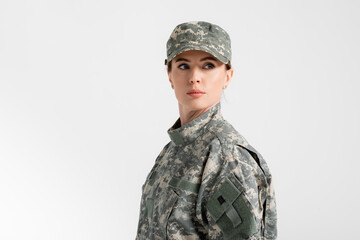 Soldier in uniform looking away isolated on grey