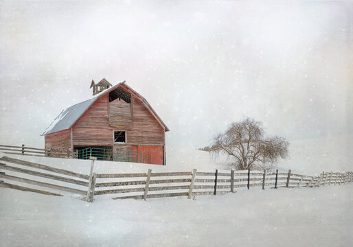 Original winter photograph of an old red barn with a long rickety wood fence in the snow