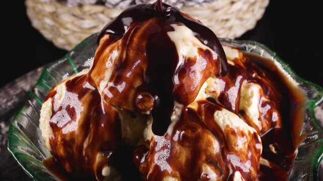 
Glass bowl of ice cream milk chocolate pouring