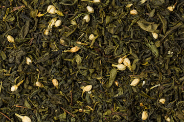 Green tea with jasmine flowers on black background