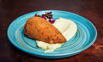 Traditional Kiev cutlet with mashed potatoes and salad