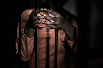 Asian man desperate at the iron prison,prisoner concept,thailand people,Hope to be free,Serious...