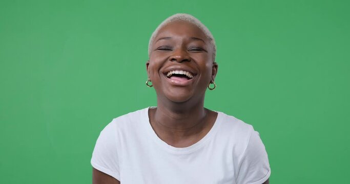 Cheerful Woman Laughing Out Loud Over Green Background