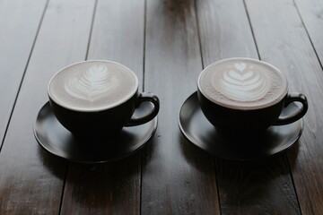 Coffee cup of cappuccino with latte art on wooden and Copy space
