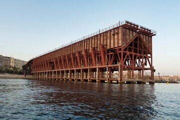 View at sunset of an iron ore loading dock built in 1904 by The Alquife Mines and Railway Company Limited, known as Cable Ingles, an example of engineering work of iron architecture - obrazy, fototapety, plakaty