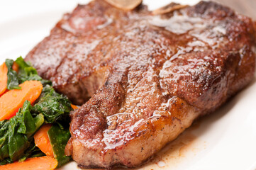t-bone steak with spinach and carrot