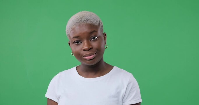 Unhappy woman regretting her wrongdoing over green background