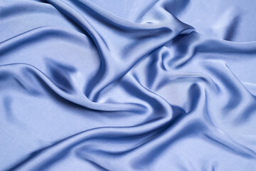 Blue silk or satin luxury fabric texture. Top view.