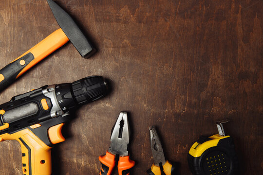 Set of different tools for work on wood background. Top view.
