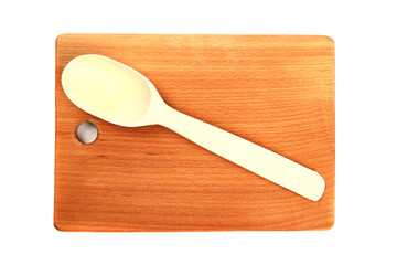 Wooden cutting board and spoon isolated on white