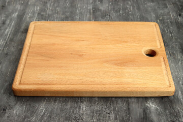 Rectangular cutting board on a gray table