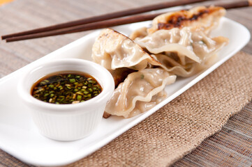 Homemade pork potstickers with a spicy dipping sauce