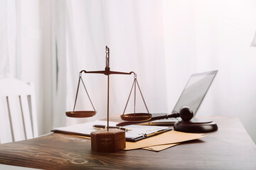 Business and lawyers discussing contract papers with brass scale on desk in office. Law, legal...