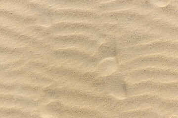 Natural sand stone texture background. sand on the beach as background. Wavy sand background for summer designs.