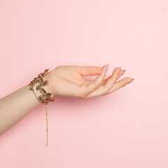 Open woman hand on pink, minimal background