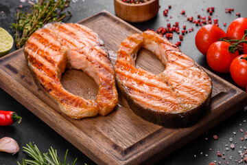 Fresh cooked delicious salmon steak with spices and herbs baked on a grill