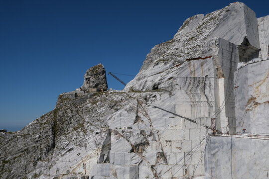 Cava di marmo. Large white marble quarry with blue sky background.