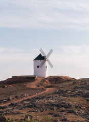 windmill in the countryside with red earth and blue sky castile la mancha don quixote europe spain