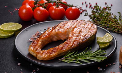Fresh cooked delicious salmon steak with spices and herbs baked on a grill