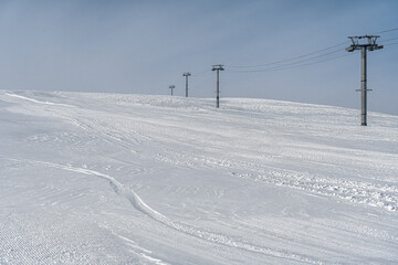 Resorts of the North Caucasus. The northern slope of the Arkhyz ski resort. Ski lift. White and blue winter landscape.
