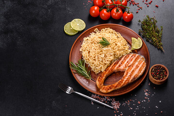 Fresh cooked delicious salmon steak with spices and herbs baked on a grill