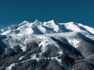 
The Arkasara ridge and the Northern slope of the Arkhyz ski resort. Winter mountain landscape. Ski trails. panoramic view of the snowy forest and mountains.