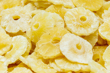 Candied fruit pieces of pineapple for sale in a market