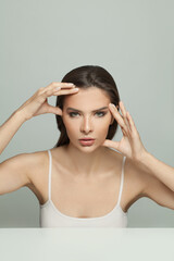 Fototapeta premium Perfect woman holding her hands near her face. Massage, cosmetology and aesthetic medicine concept