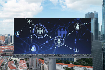 Glowing Social media icons on road billboard over panoramic city view of Singapore, Southeast Asia. The concept of networking and establishing new connections between people and businesses.