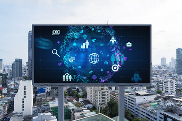 World planet Earth map hologram and social media icons on billboard over panorama city view of Bangkok, Southeast Asia. The concept of people networking and connections.