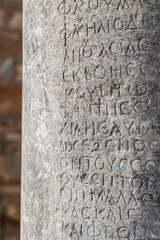Ancient greek inscriptions on the ruins of column in ancient Ephesus city in Turkey