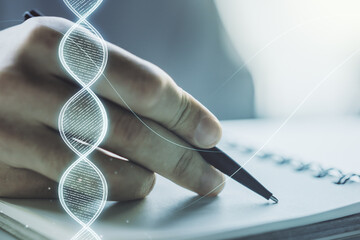 Creative light DNA illustration and man hand writing in diary on background, science and biology...